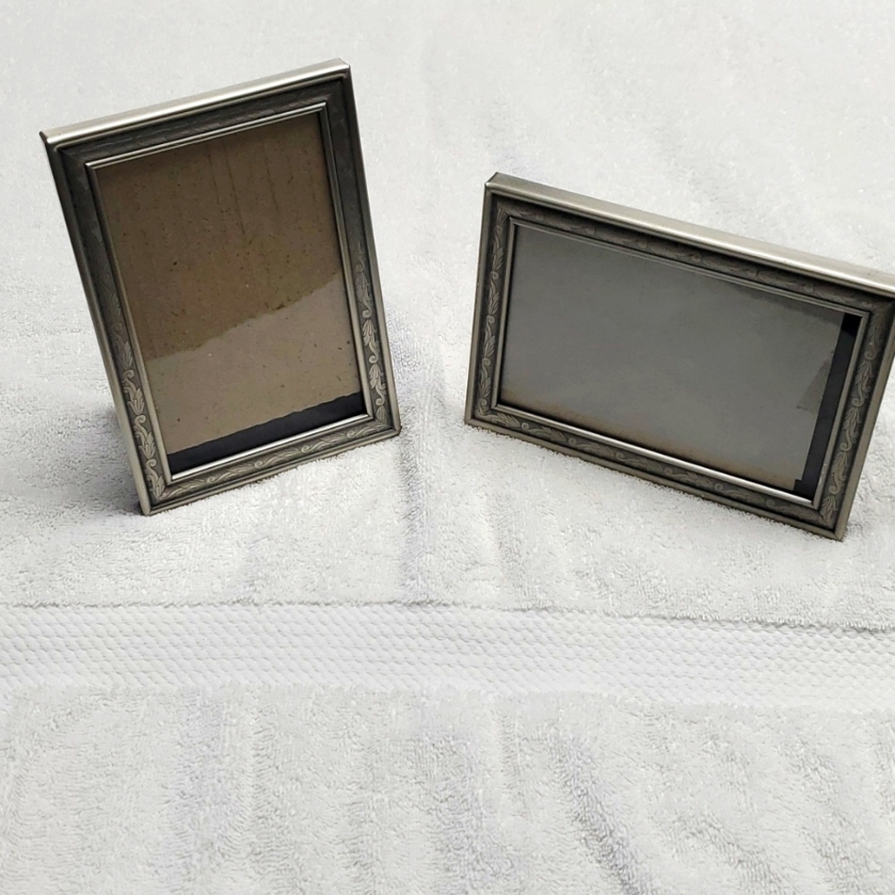 2 silver picture frames with glass. Black backing.